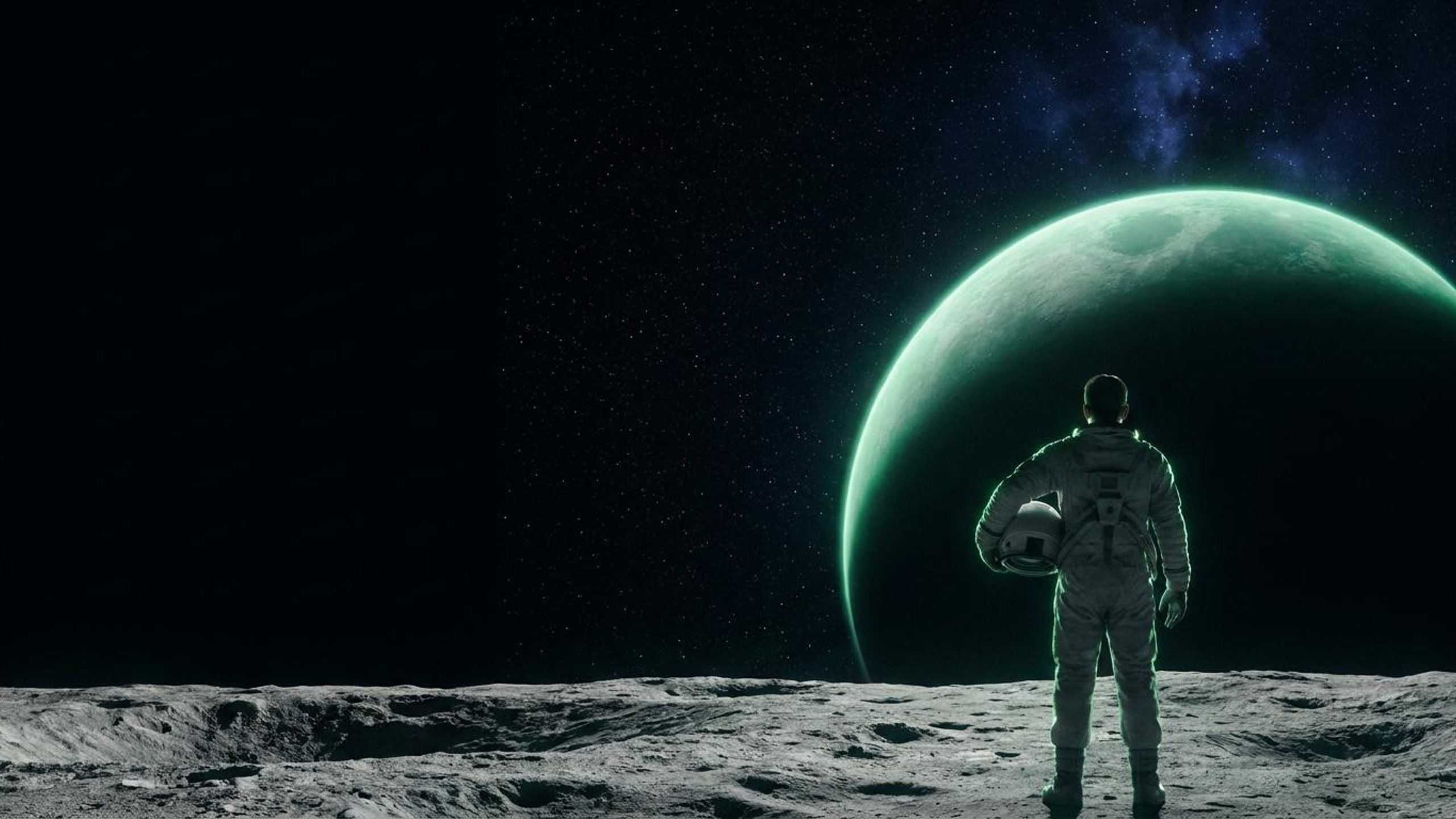 An astronaut standing on the moon, helmet in hand, looking out at a green planet